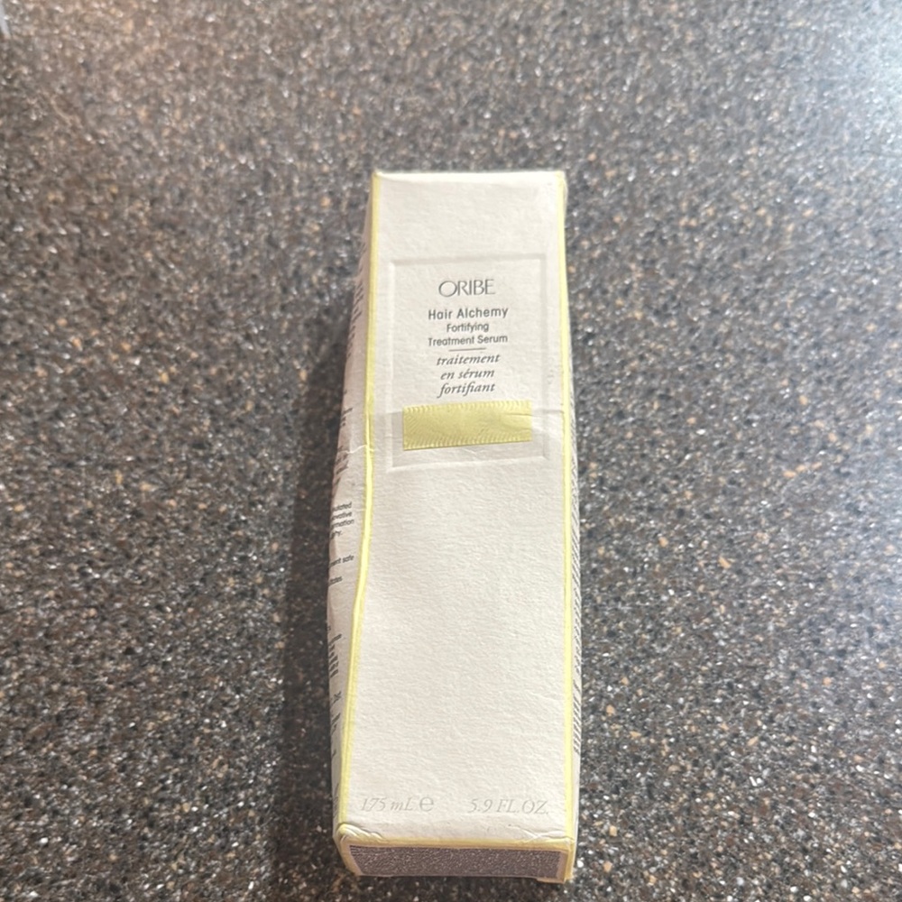 Oribe Hair Alchemy Serum in White and Yellow